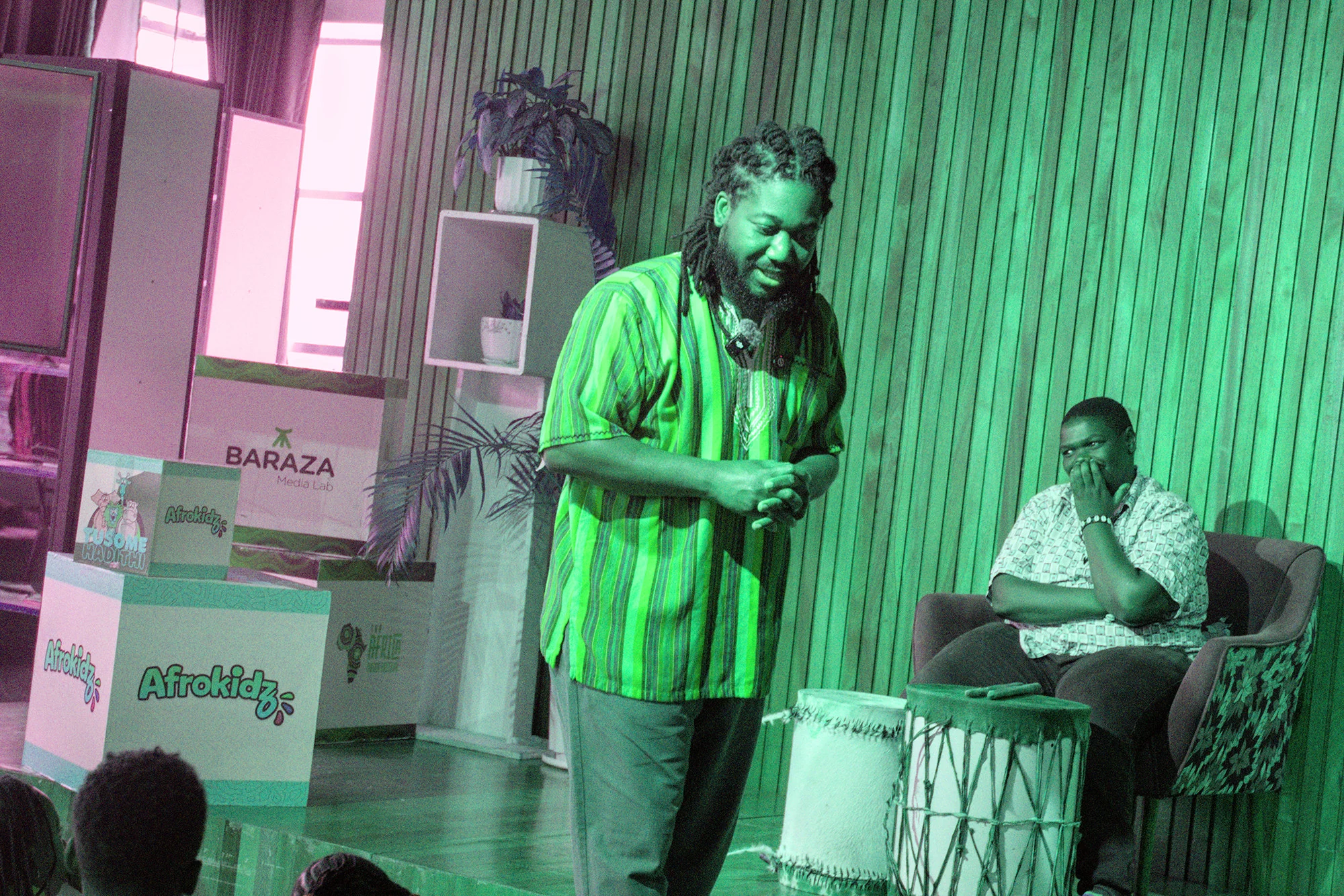 Bernard performing beside a drummer at the Afrokidz reading event